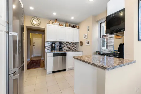 a kitchen with granite countertop a sink and a stove top oven