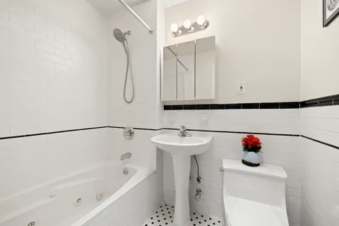 a bathroom with a sink vanity and bathtub
