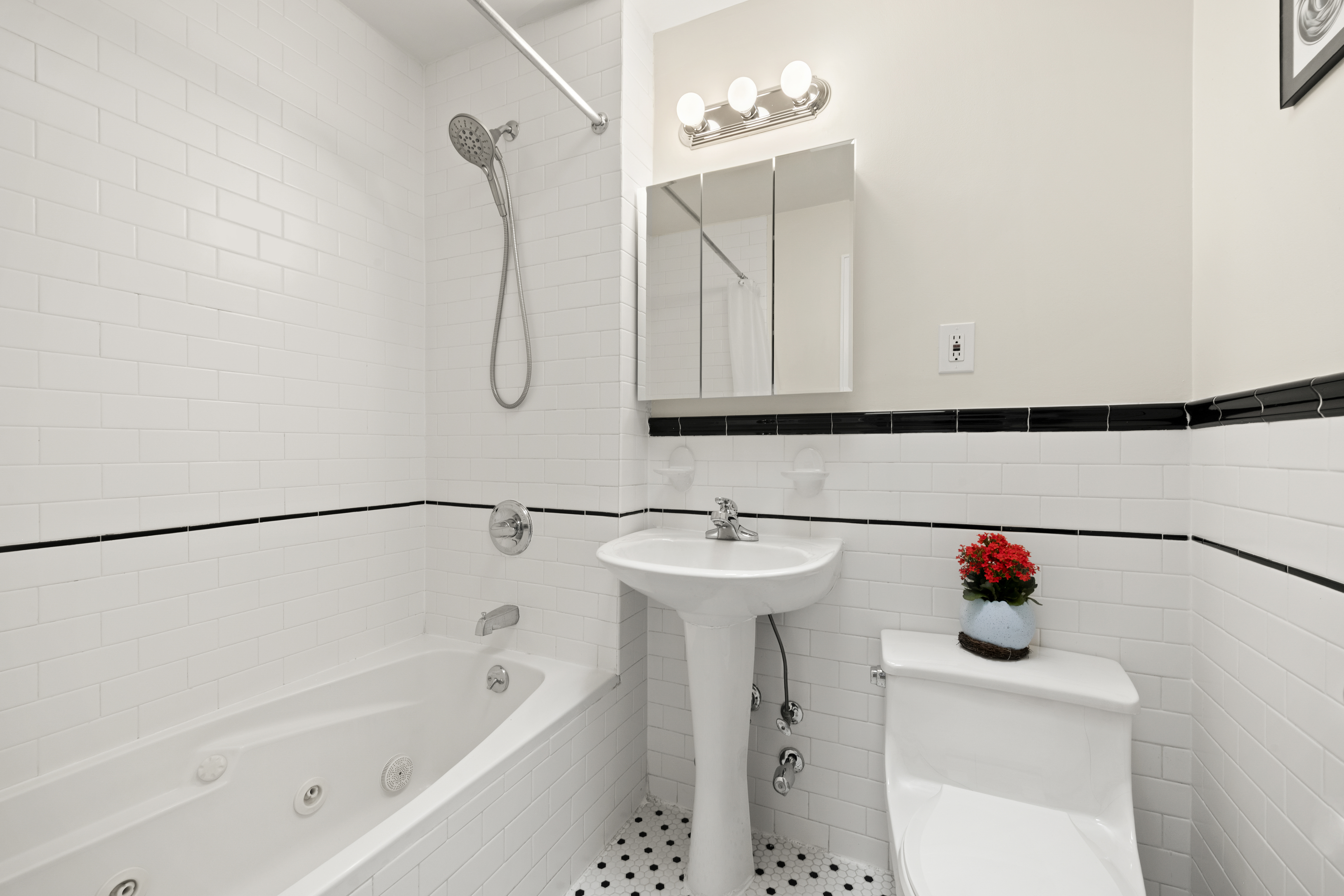370 St Nicholas Avenue, Unit PH5B Manhattan, NY 10027 - Photo 11 of 12 a bathroom with a sink vanity and bathtub