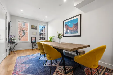 a large kitchen with a table and chairs in it