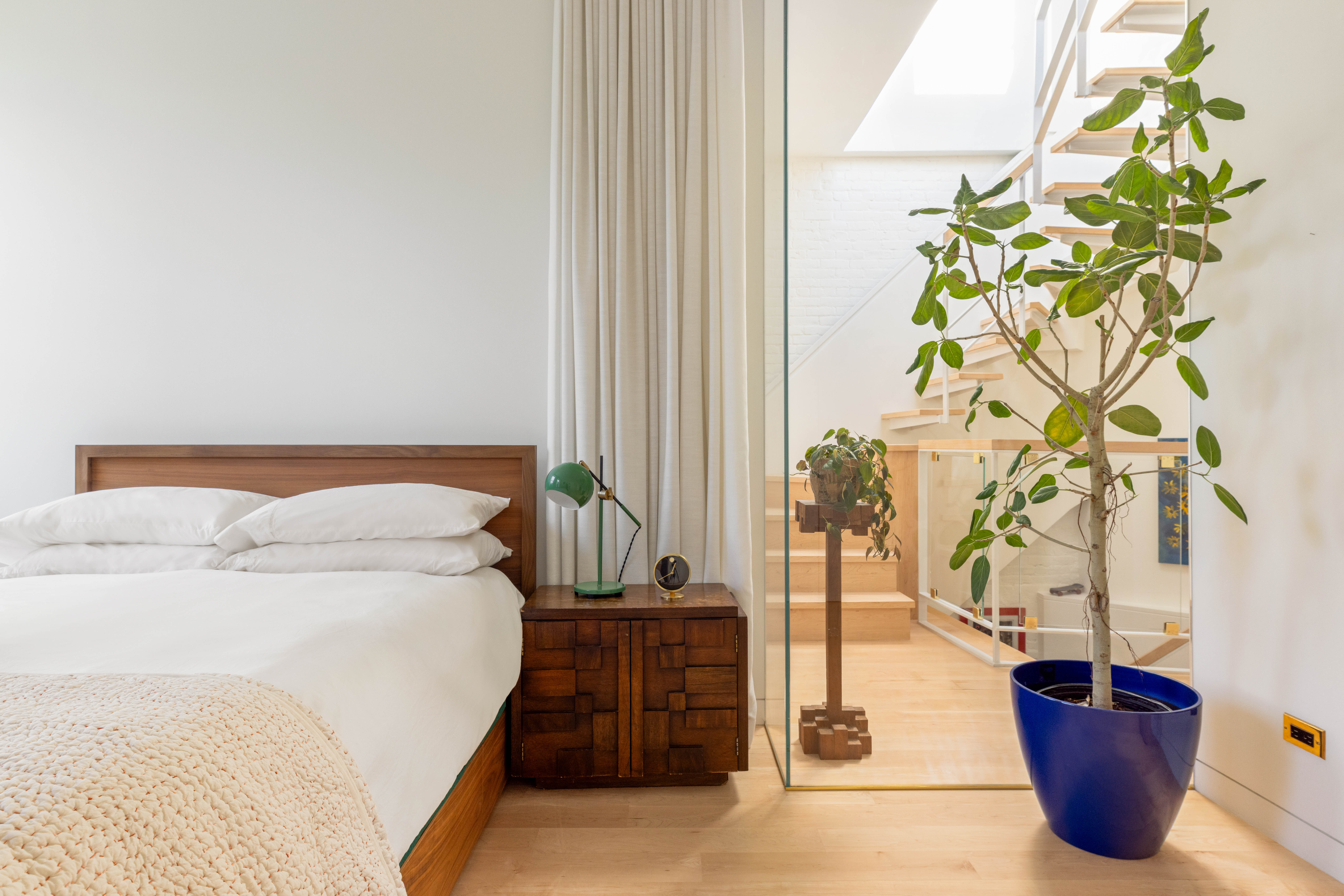 130 Jane Street, Unit 5/6F Manhattan, NY 10014 - Photo 16 of 23 a bed sitting in a bedroom next to a window