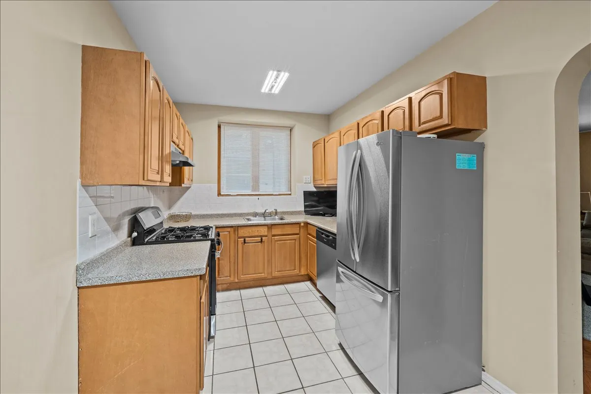 a bedroom with a bed wooden floor and a chandelier