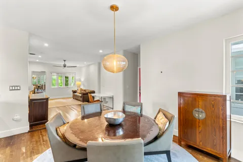 a dining room with furniture and wooden floor