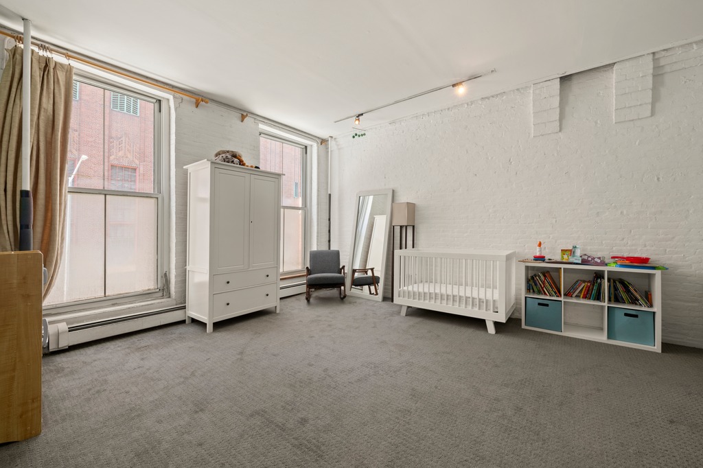 13 Worth Street, Unit 11 Manhattan, NY 10013 - Photo 7 of 9 a view of a livingroom with furniture and a ceiling fan