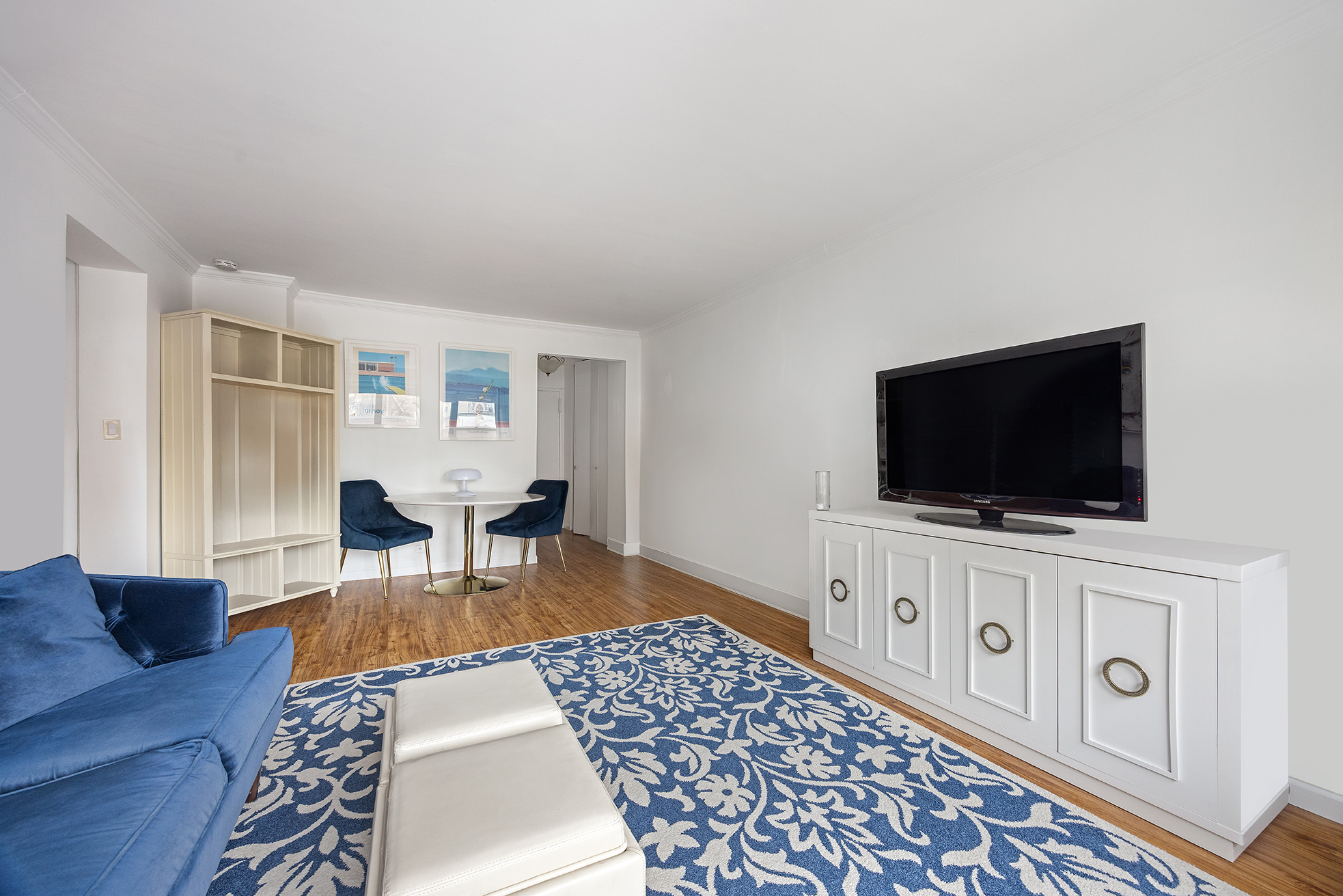120 East 90th Street, Unit 7B Manhattan, NY 10128 - Photo 3 of 8 a living room with furniture and a flat screen tv