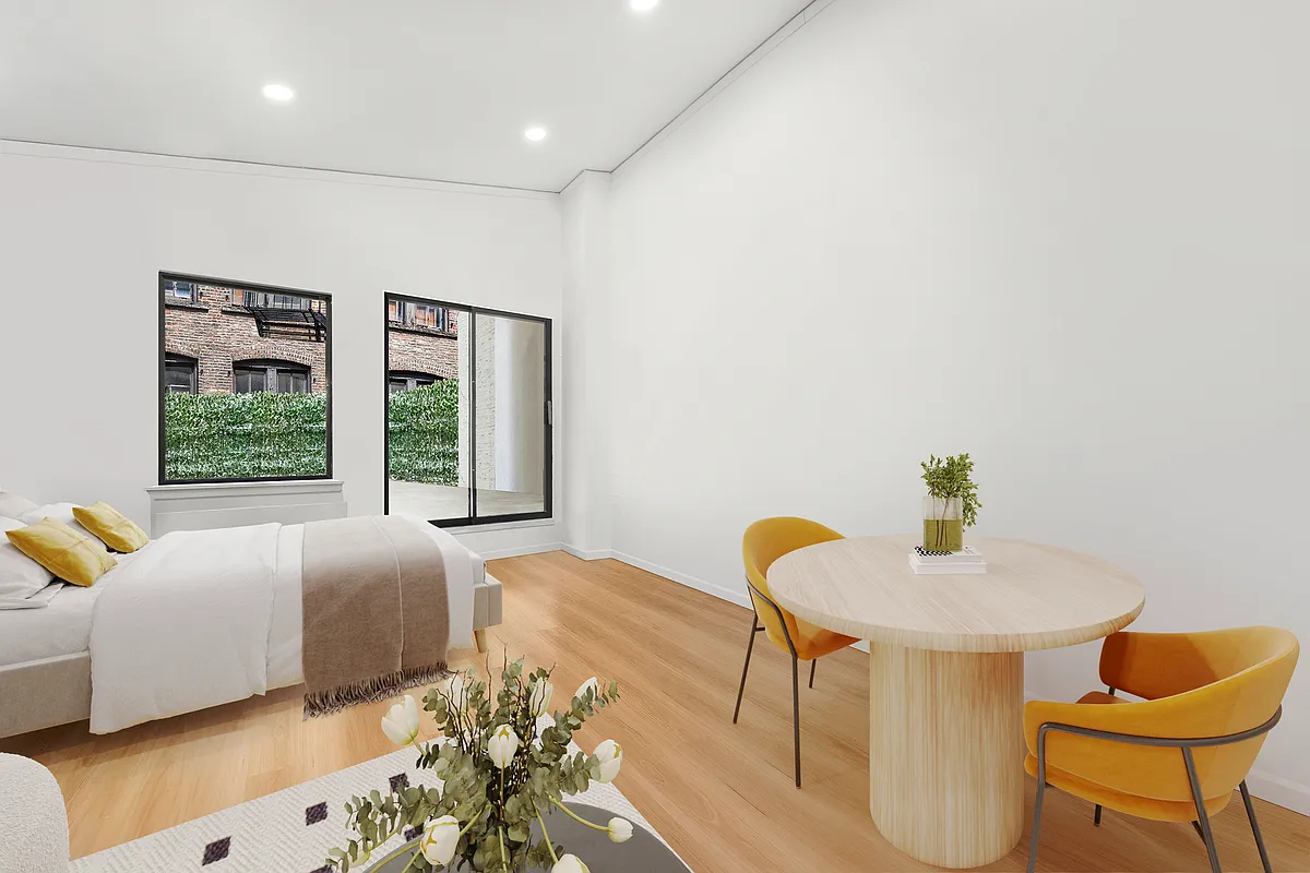 35 East 10th Street, Unit 2G Manhattan, NY 10003 - Photo 3 of 11 a bedroom with a bed and chair