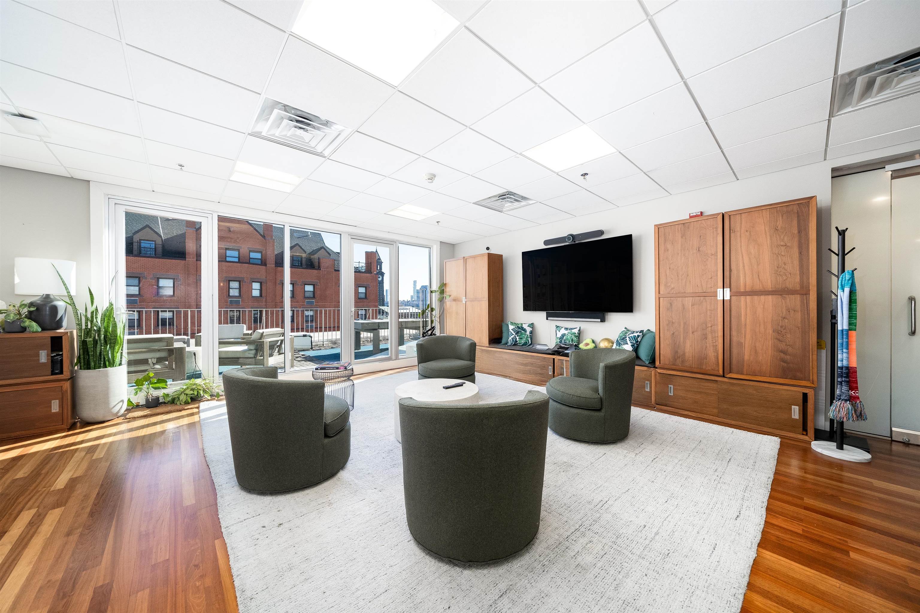 80 River Street, Unit PHNORTH Hoboken, NJ 07030 - Photo 2 of 24 a living room with furniture and a flat screen tv