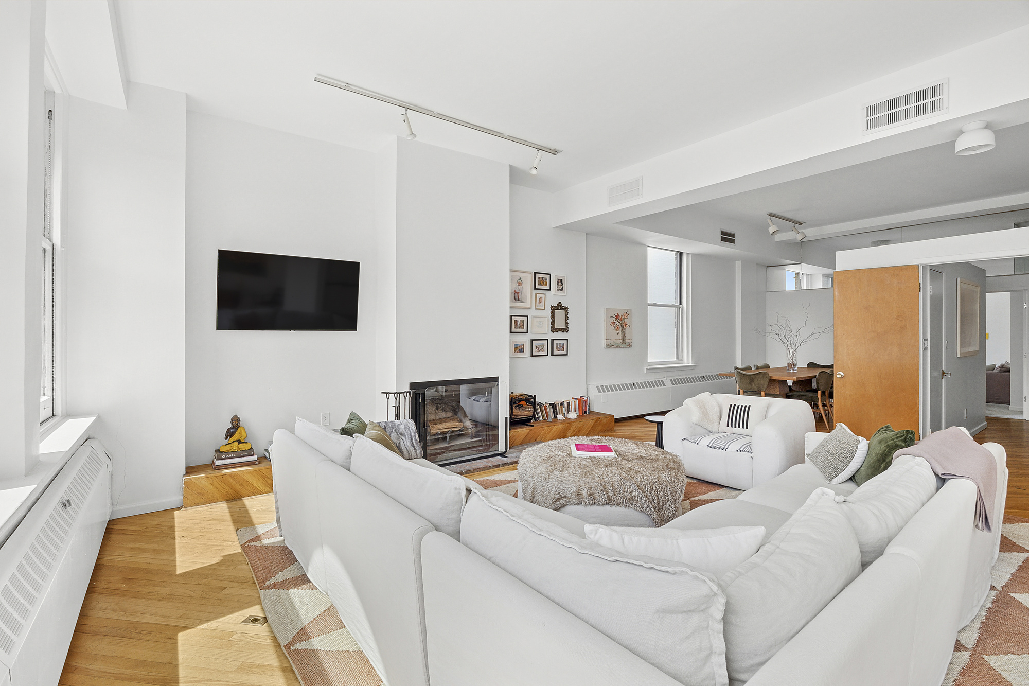 35 East 12th Street, Unit 8C Manhattan, NY 10003 - Photo 20 of 22 a living room with furniture and a flat screen tv
