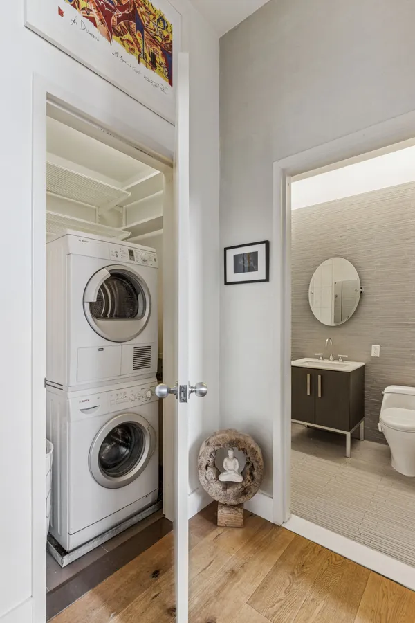 a living room with a washer and dryer