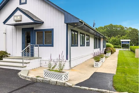a front view of a house with garden
