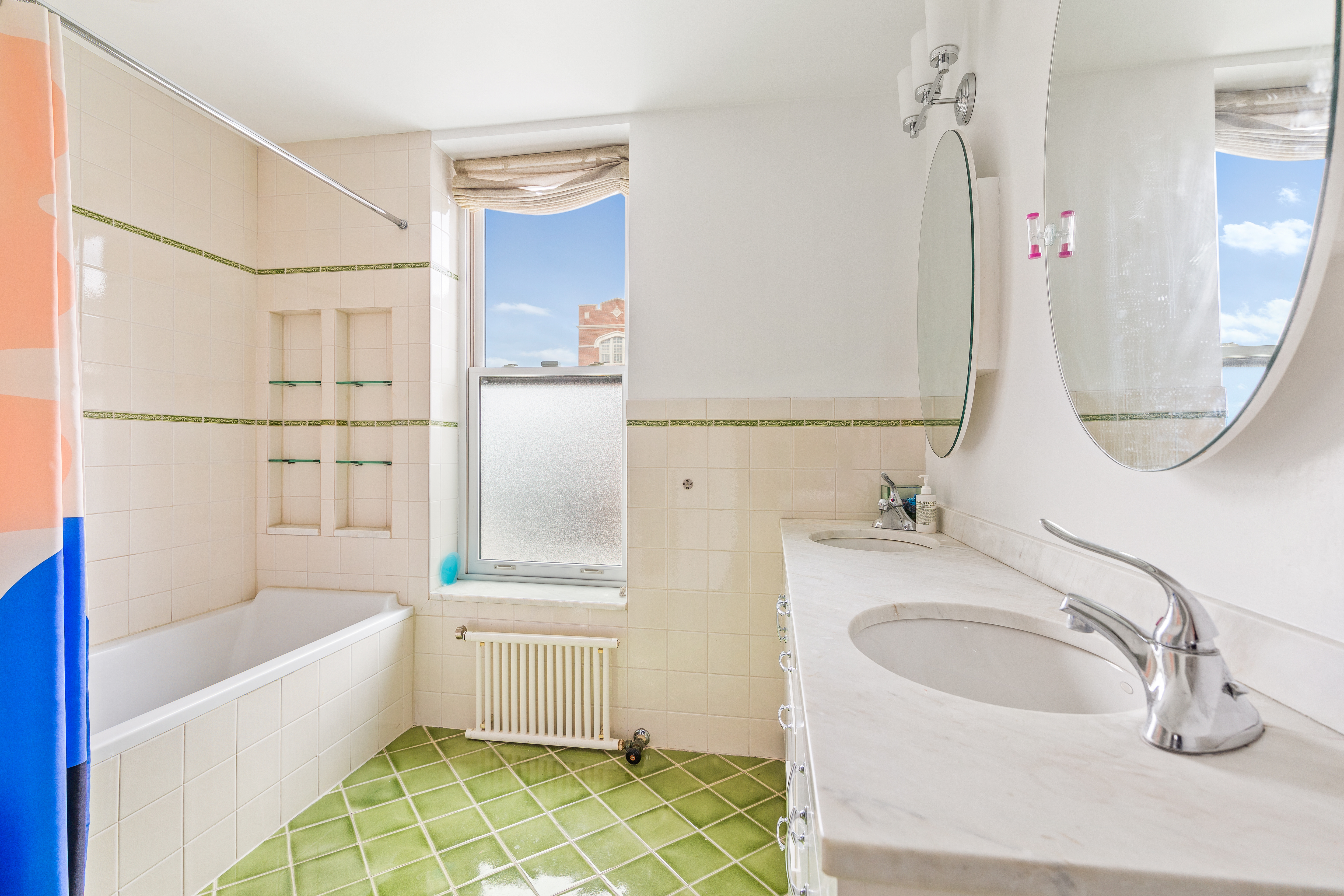 176 Warren Street Brooklyn, NY 11201 - Photo 9 of 13 a bathroom with a tub sink and mirror