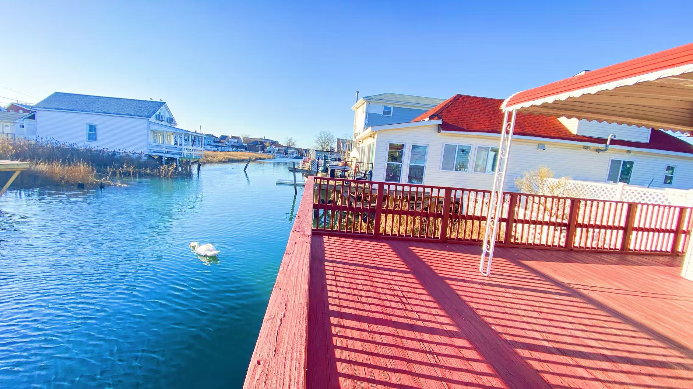 10 Church Street Queens, NY 11414 - Photo 12 of 14 a view of a balcony with wooden floor and iron stairs