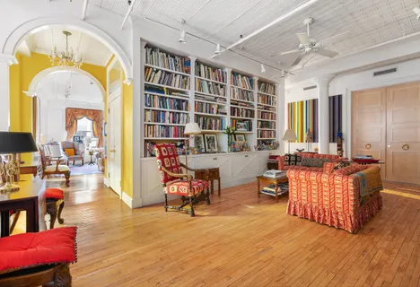 a living room filled with furniture hardwood floor and a chandelier