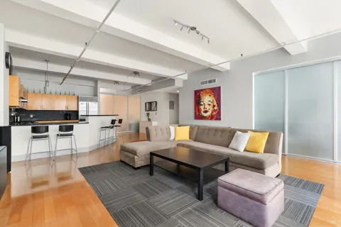a living room with furniture wooden floor and a flat screen tv