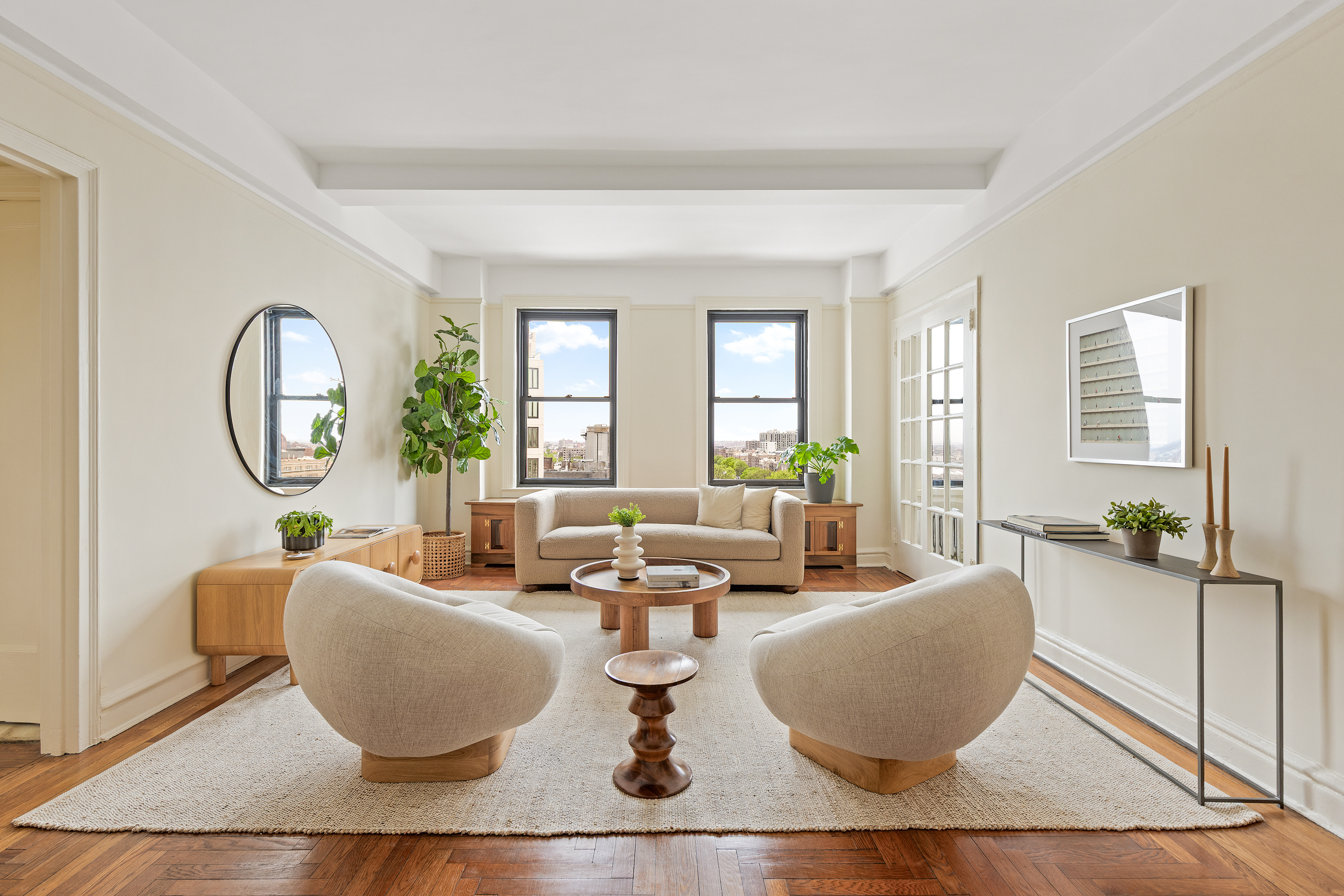 a living room with fireplace furniture and a large window