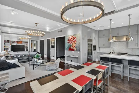 a very nice looking dining room with a large window and stainless steel appliances