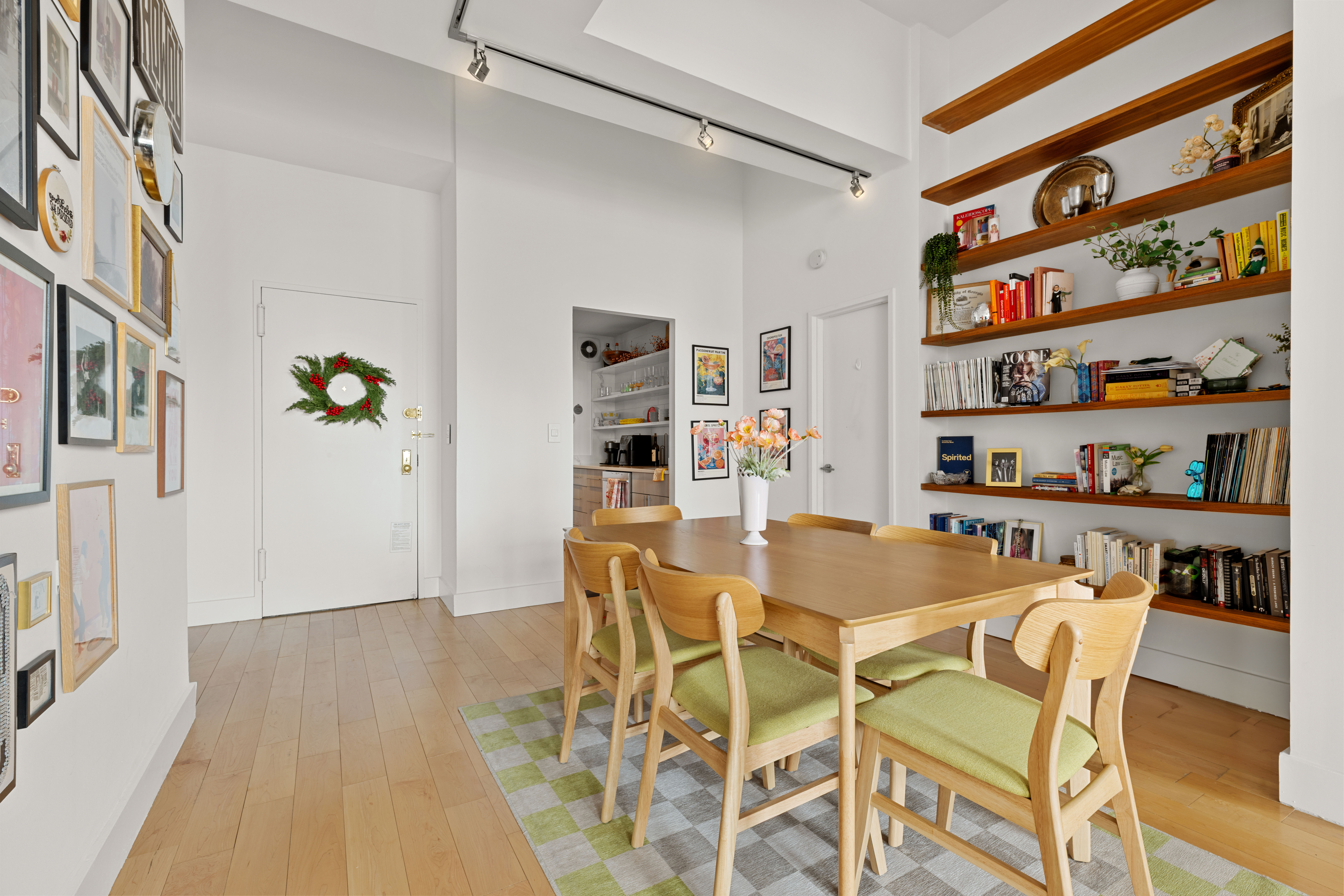 310 East 46th Street, Unit 22U Manhattan, NY 10017 - Photo 3 of 9 a dining room with furniture and a book shelf