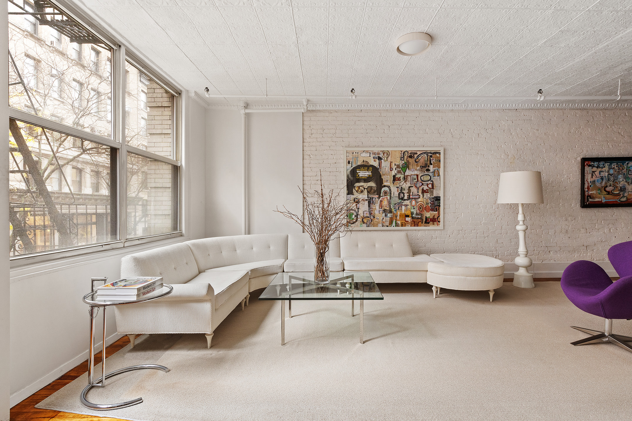 25 West 15th Street, Unit 3 Manhattan, NY 10011 - Photo 5 of 19 a living room with furniture and a large window