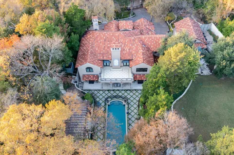 an aerial view of a house with a yard and garden