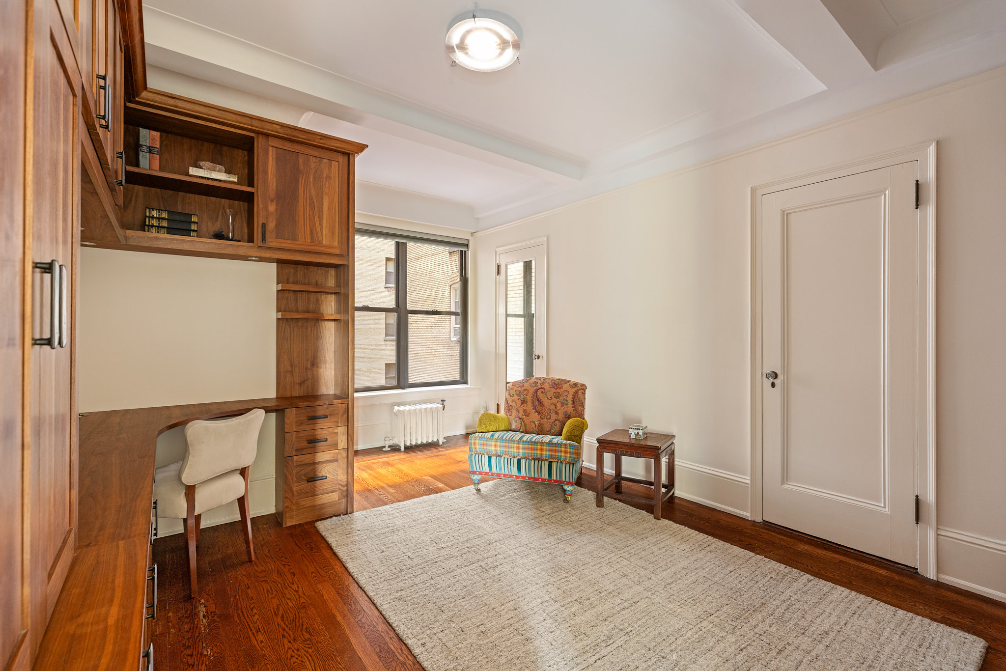 186 Riverside Drive, Unit 5F Manhattan, NY 10024 - Photo 11 of 15 a living room with furniture and a window