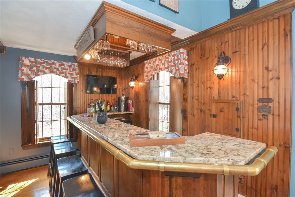 a bathroom with a granite countertop sink and a large mirror