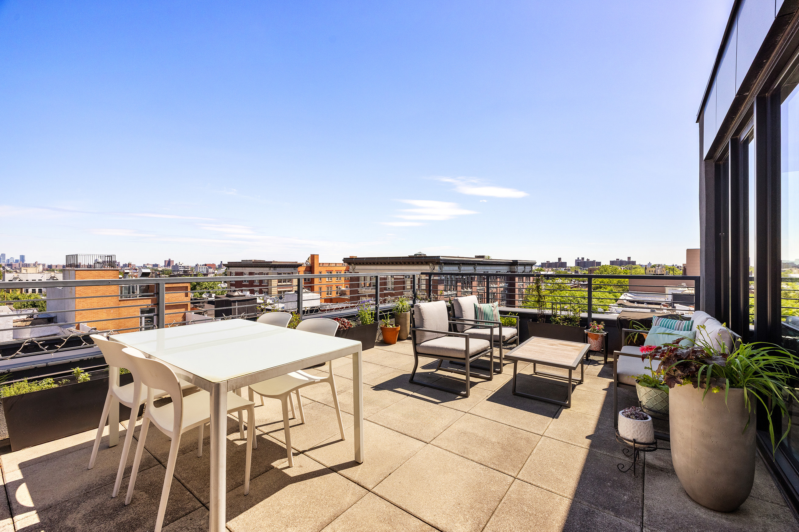 762 Park Place, Unit PH1 Brooklyn, NY 11216 - Photo 12 of 15 a view of a terrace with furniture and garden