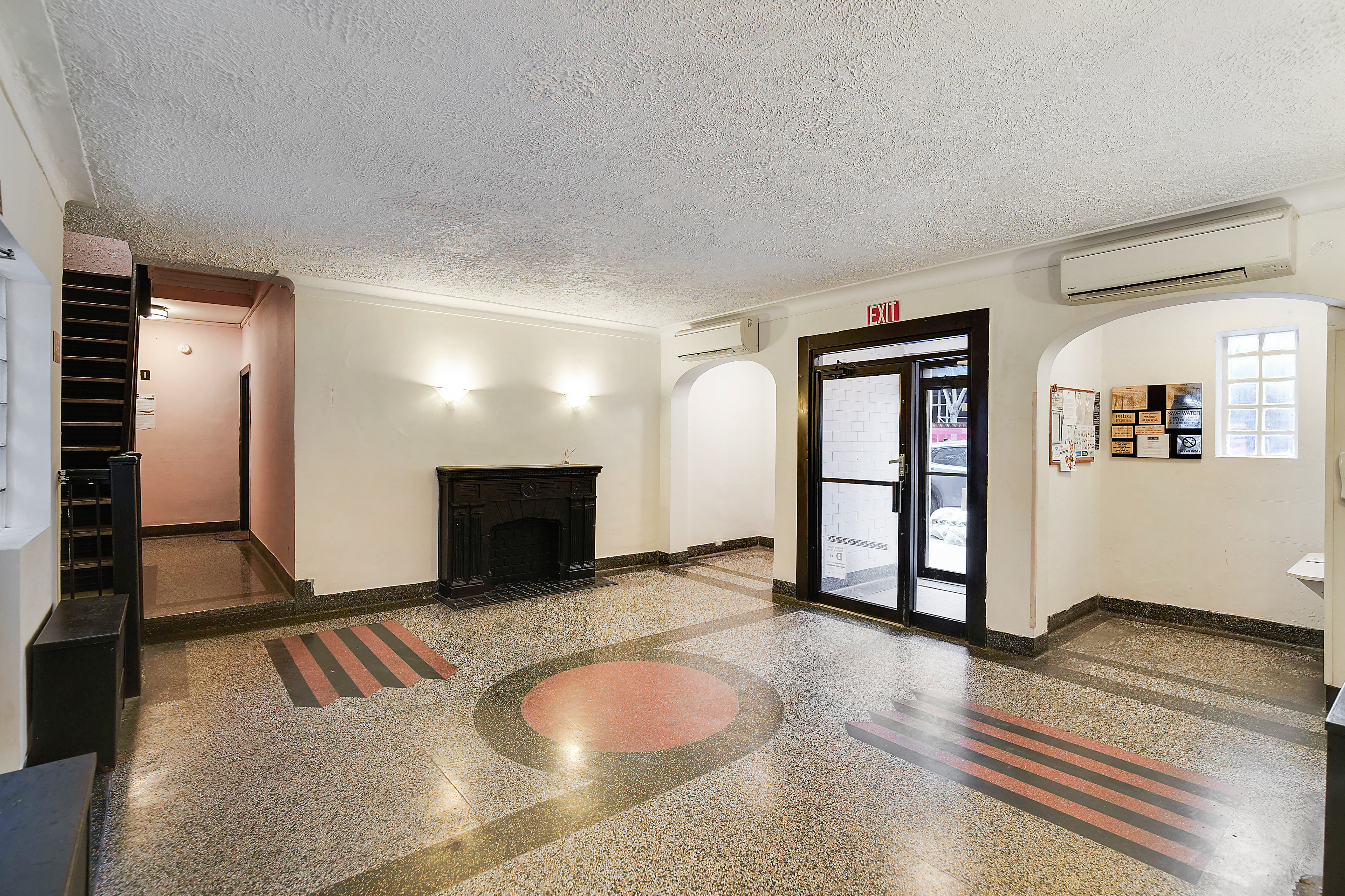 240 East 24th Street, Unit 4G Manhattan, NY 10010 - Photo 7 of 10 a view of a livingroom with furniture and fireplace