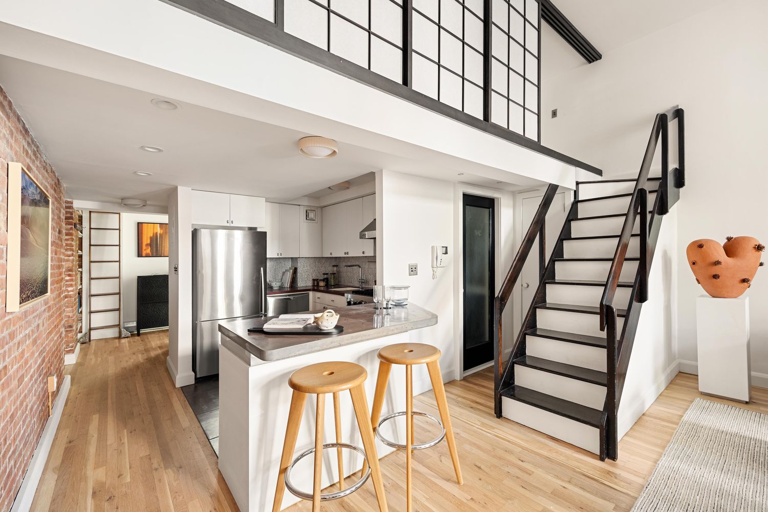 a kitchen with stainless steel appliances kitchen island granite countertop a refrigerator and a stove top oven