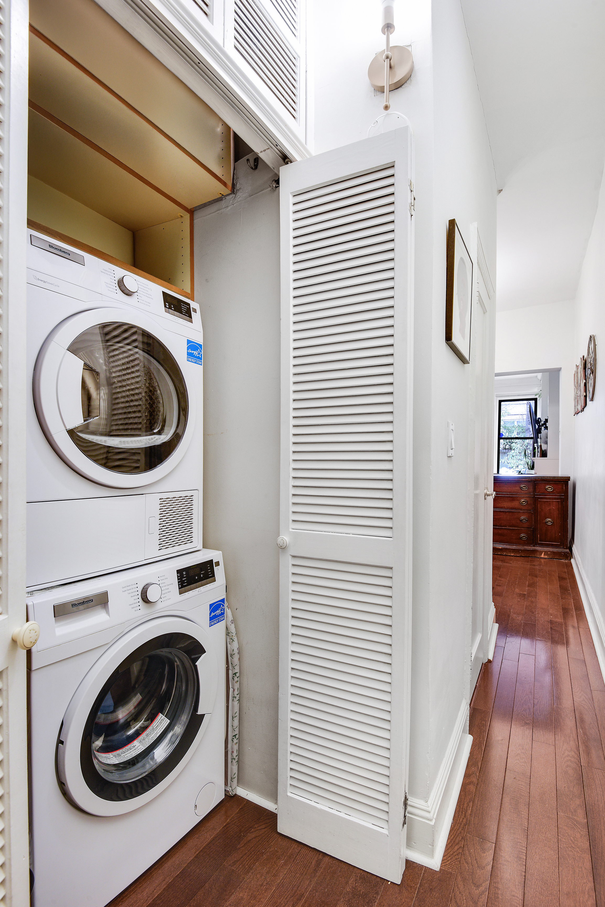 436 East 66th Street, Unit 1W Manhattan, NY 10065 - Photo 10 of 19 a view of a hallway with washer and dryer