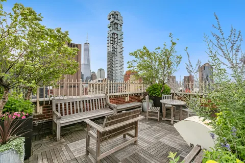 a view of a patio with a table and chairs