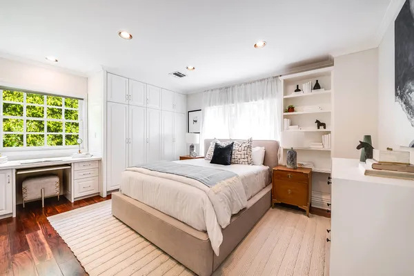 a bedroom with a large bed and a fireplace