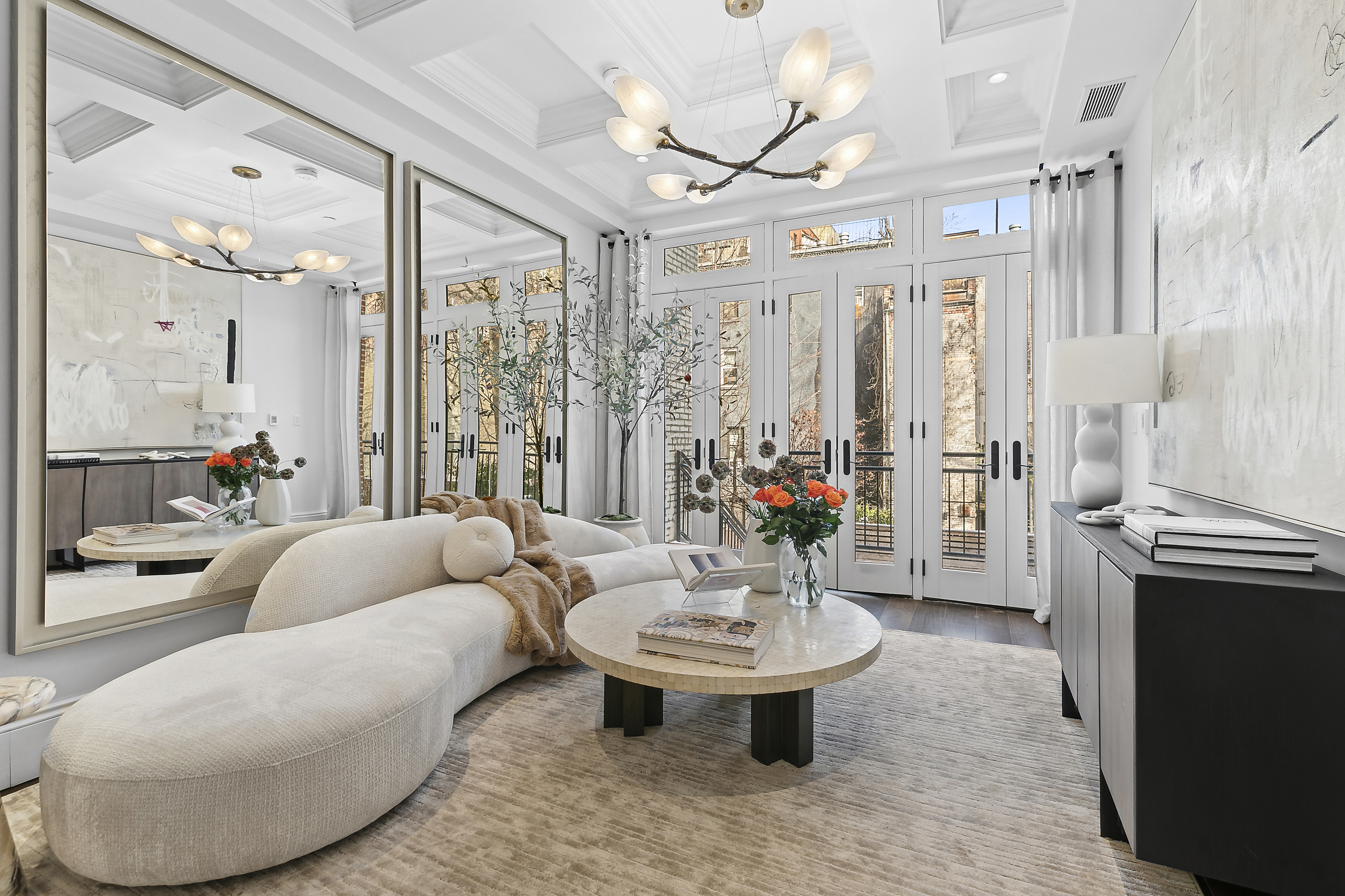 a living room with furniture and a chandelier