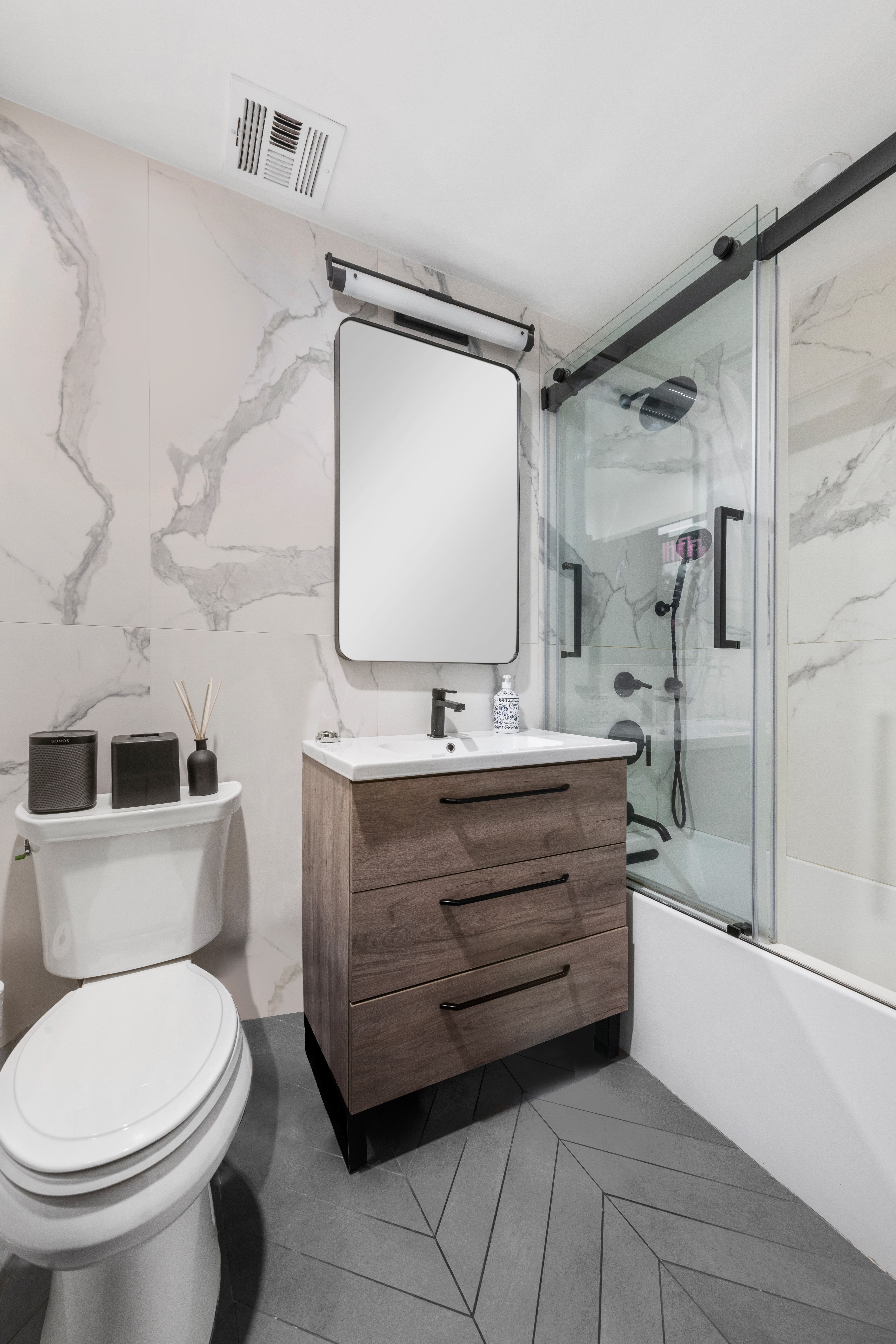 21 West 9th Street, Unit 1F Manhattan, NY 10011 - Photo 6 of 11 a bathroom with a sink a toilet and shower