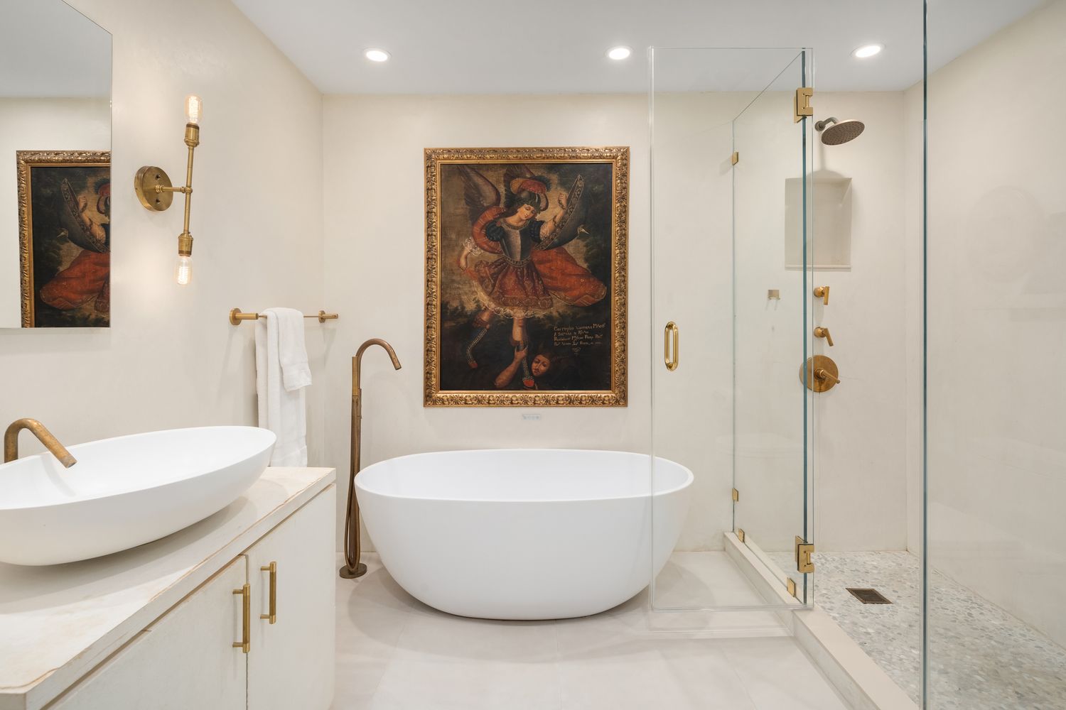a white bath tub sitting next to a bathroom sink