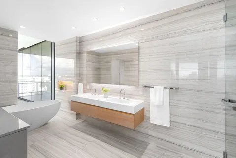 a spacious bathroom with a double vanity sink a mirror and a bathtub