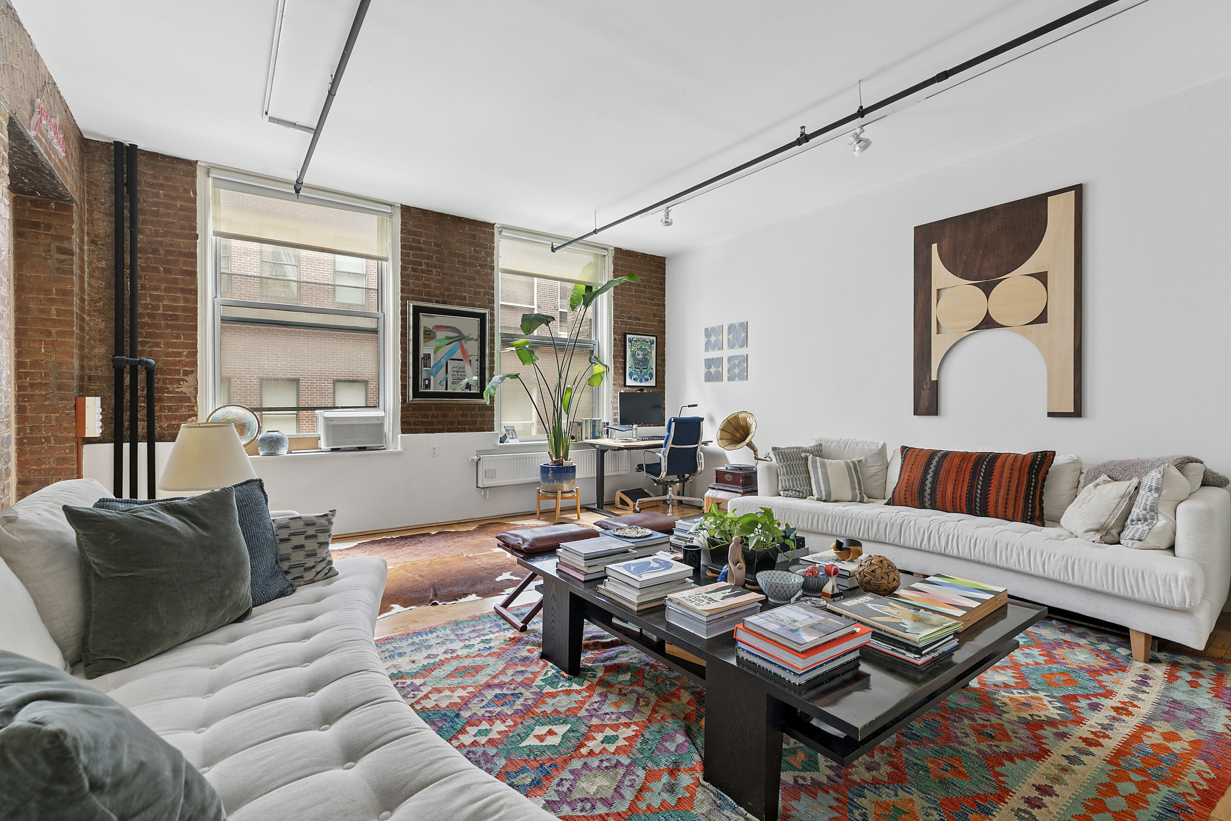 108 Wooster Street, Unit 4C Manhattan, NY 10012 - Photo 3 of 9 a living room with furniture and a large window
