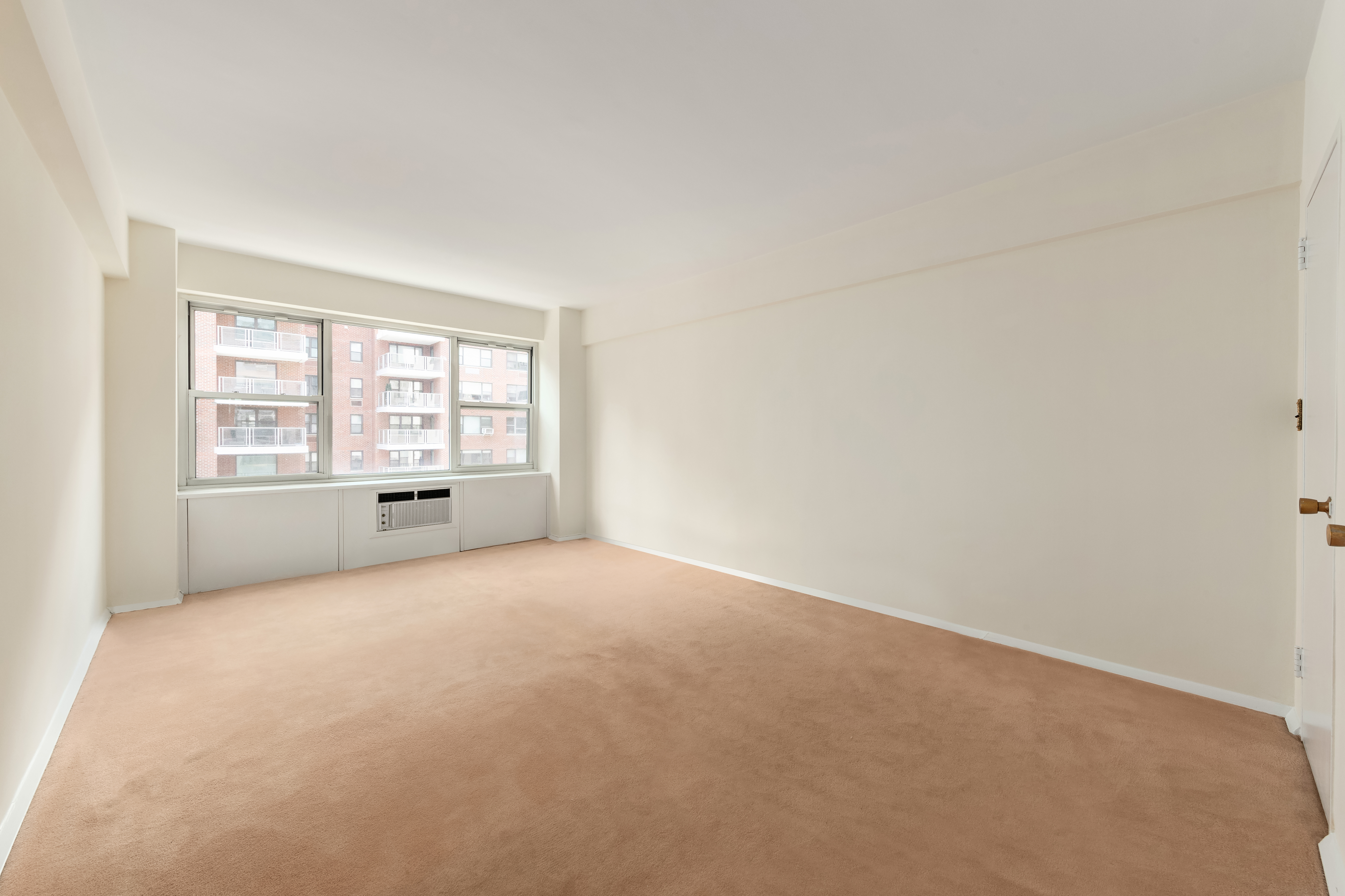 45 Sutton Place South, Unit 14N Manhattan, NY 10022 - Photo 11 of 19 an empty room with windows