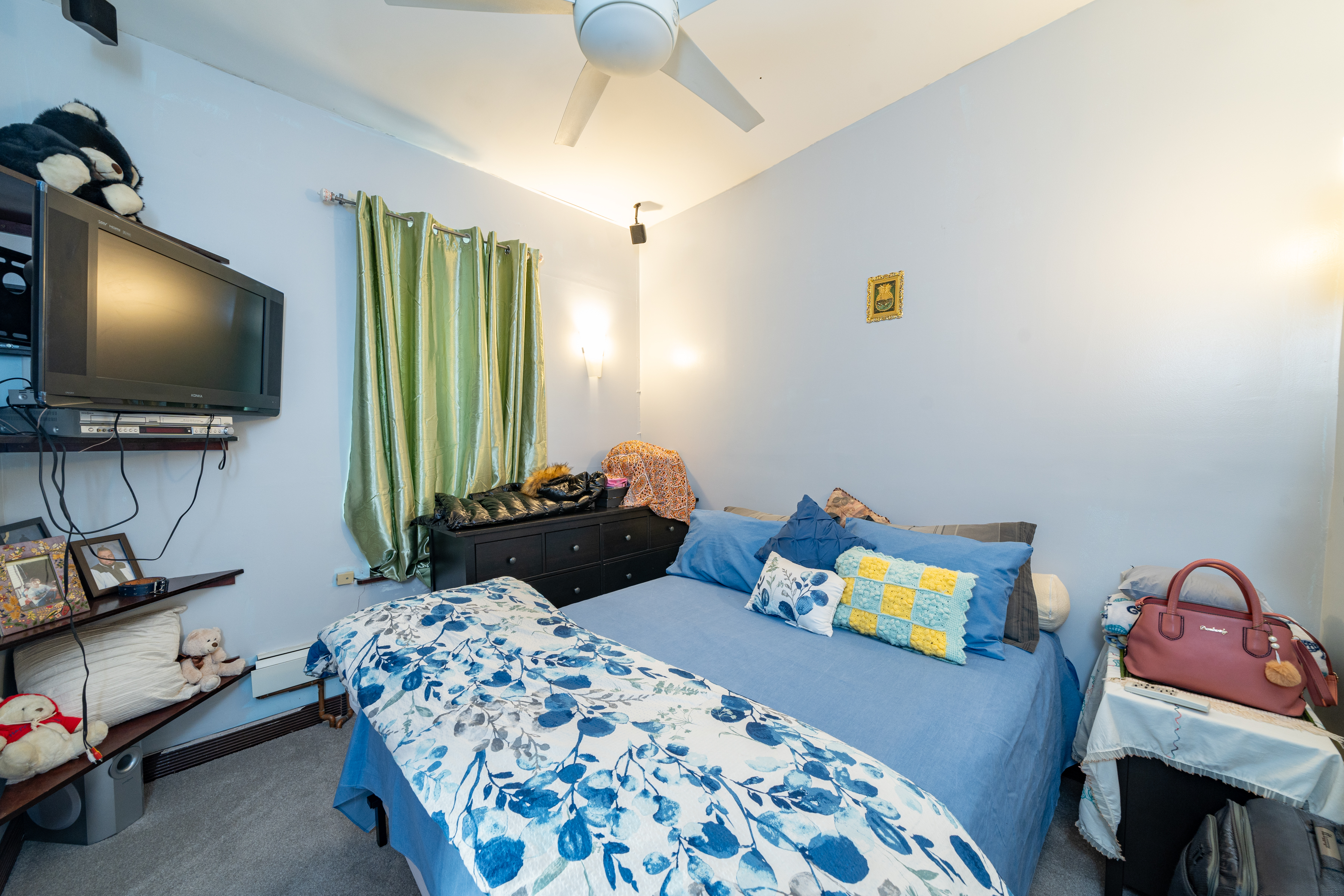 415 84th Street Brooklyn, NY 11209 - Photo 14 of 17 a bedroom with a bed and a flat screen tv