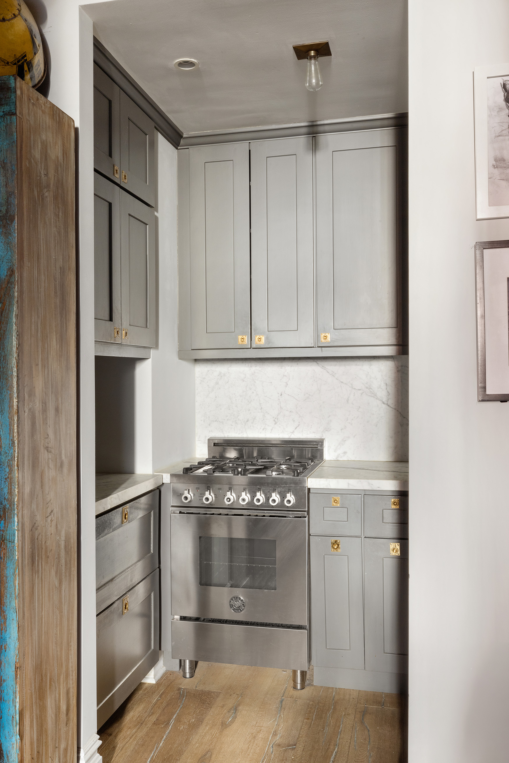 221 West 21st Street, Unit 1C Manhattan, NY 10011 - Photo 5 of 9 a kitchen with granite countertop a cabinets and steel stainless steel appliances