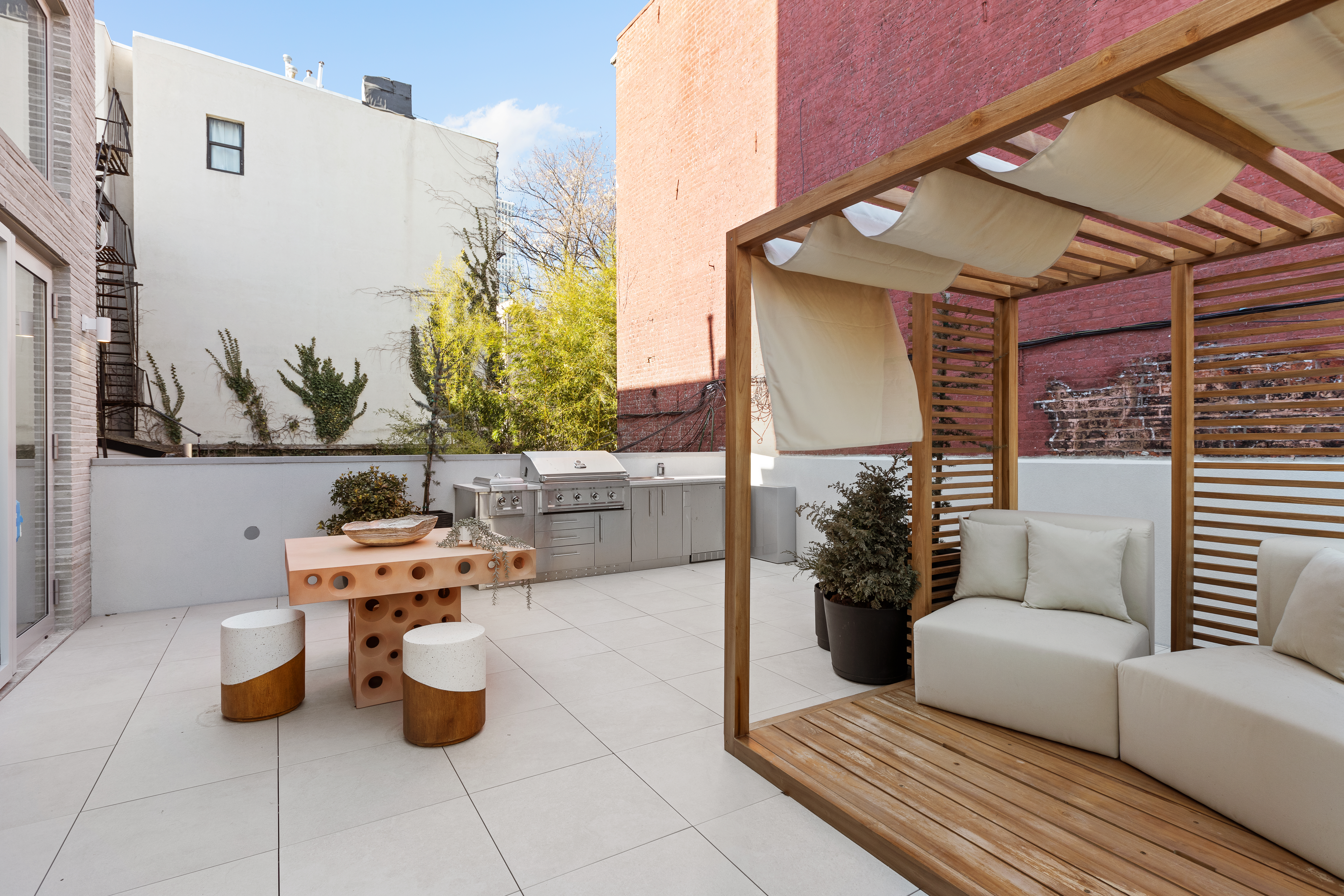 276 Berry Street Brooklyn, NY 11249 - Photo 10 of 36 a view of a patio with couches and potted plants