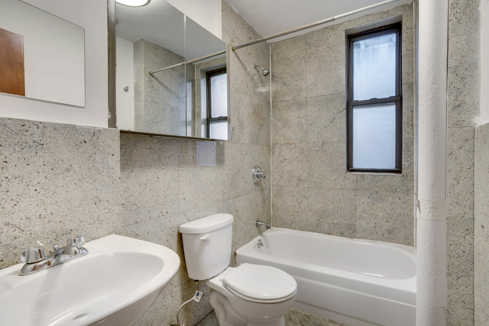 1392 Madison Avenue, Unit 4 Manhattan, NY 10128 - Photo 4 of 4 a bathroom with a toilet a sink and bathtub