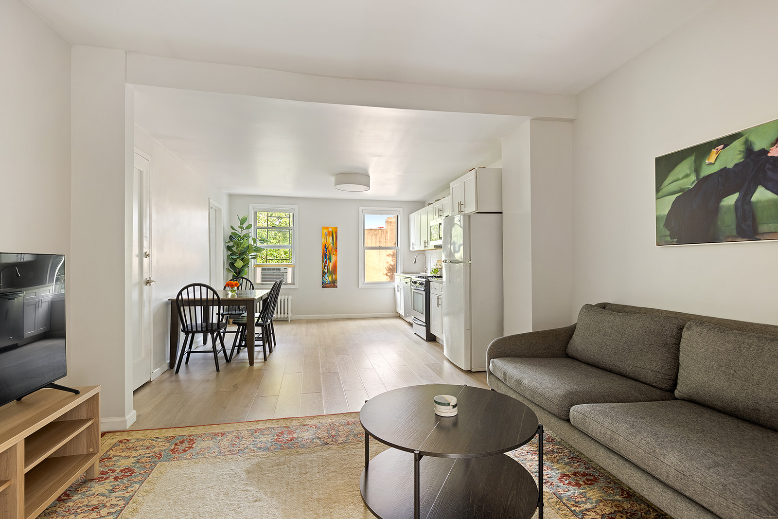 682 A 6th Avenue Brooklyn, NY 11215 - Photo 11 of 16 a living room with furniture and a dining table with wooden floor
