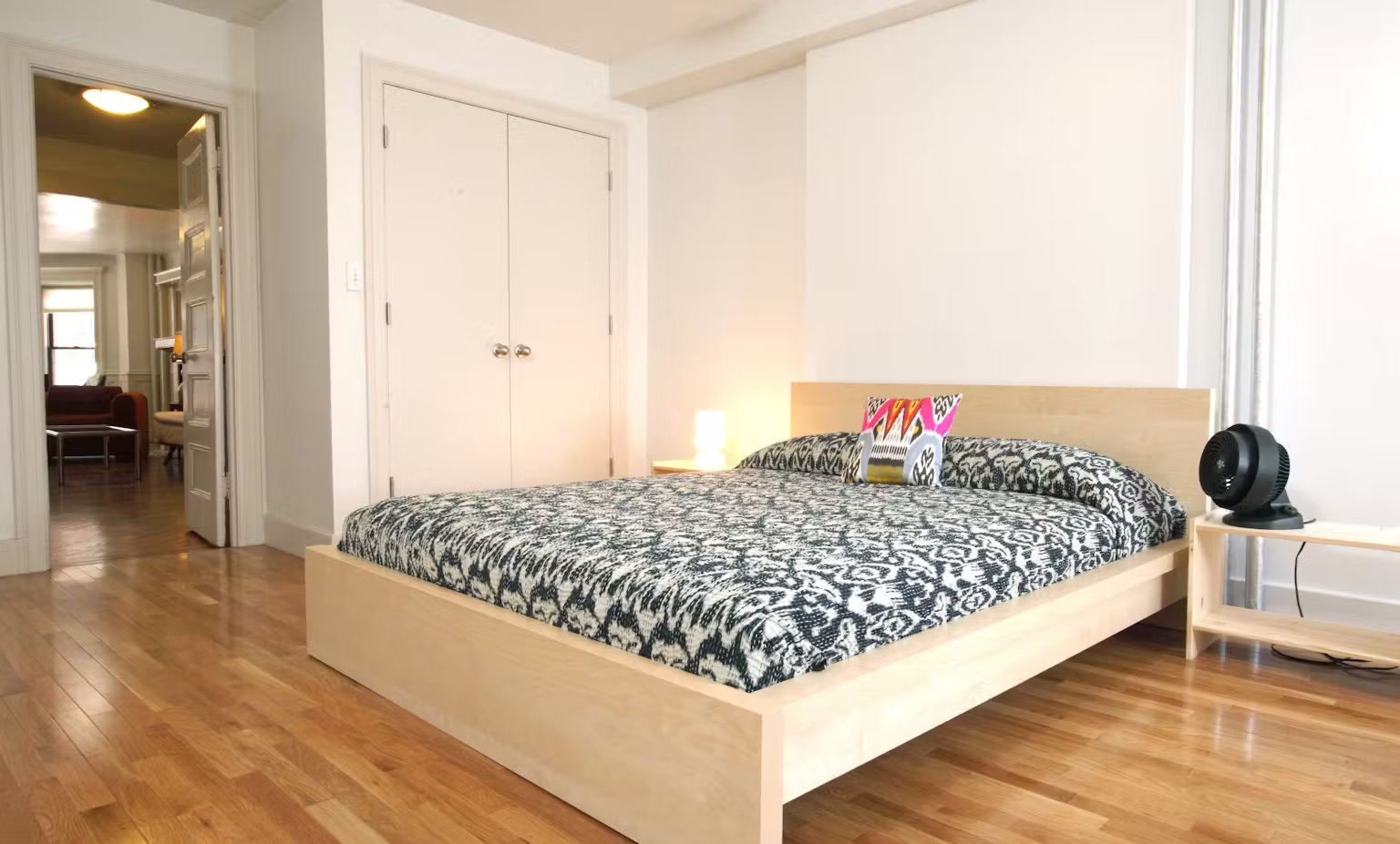 899 Lincoln Place, Unit 1 Brooklyn, NY 11213 - Photo 5 of 9 a bed sitting in a bedroom next to a window and a flat screen tv