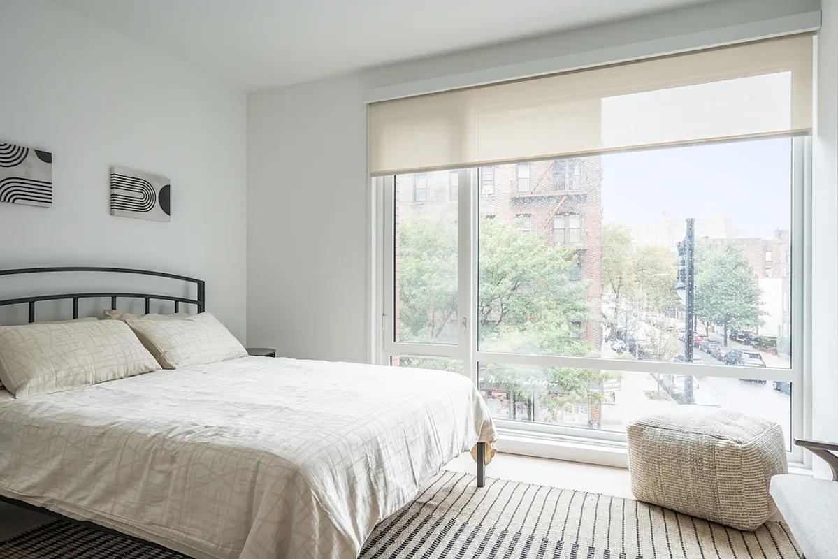 975 Nostrand Avenue, Unit 209 Brooklyn, NY 11225 - Photo 3 of 14 a bedroom with a large bed and a large window
