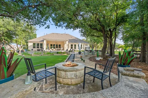 a view of a house with backyard porch and sitting area