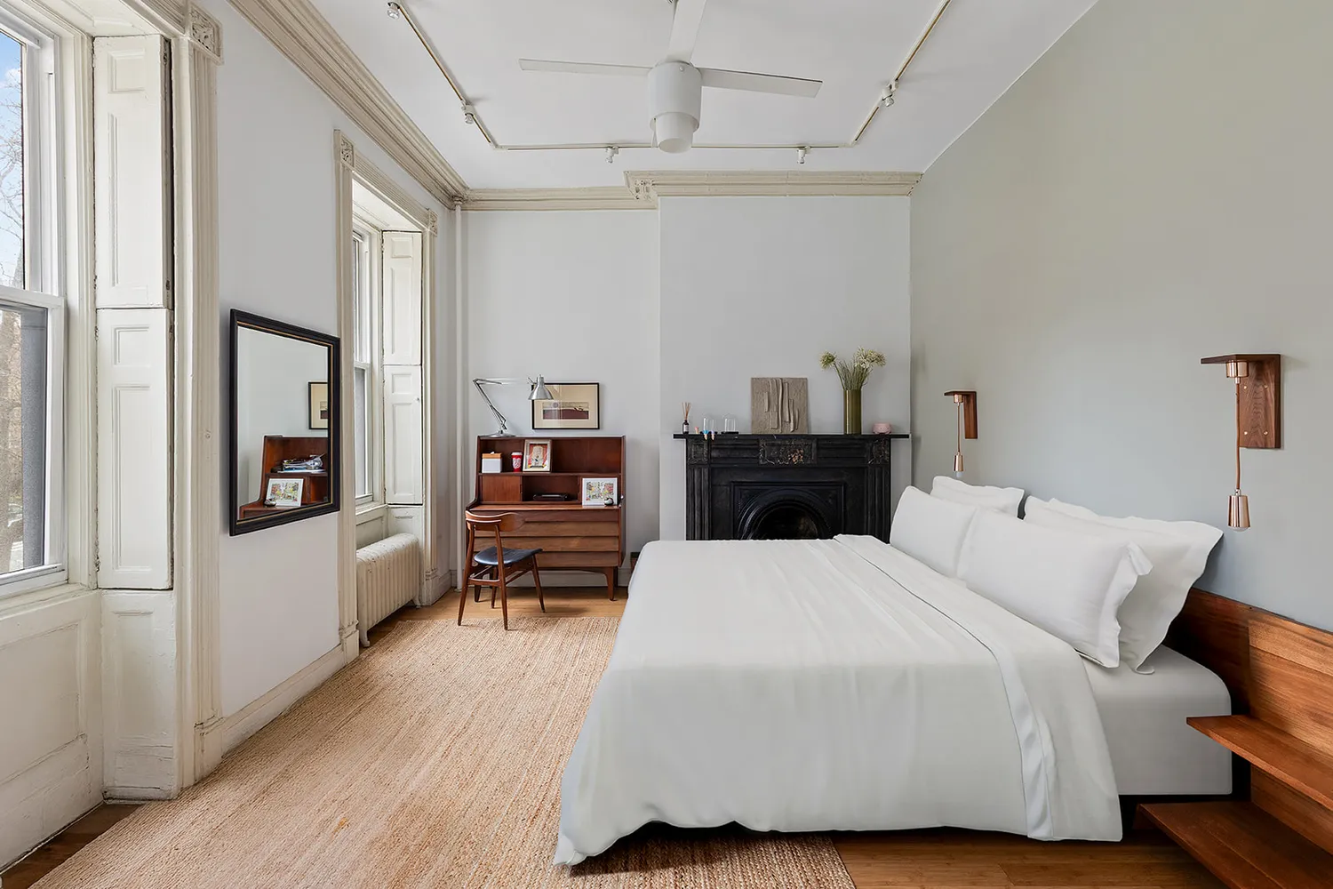 a bedroom with a bed and wooden floor