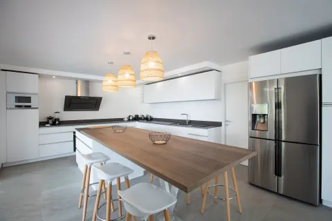 a kitchen with stainless steel appliances granite countertop a sink a refrigerator and a stove