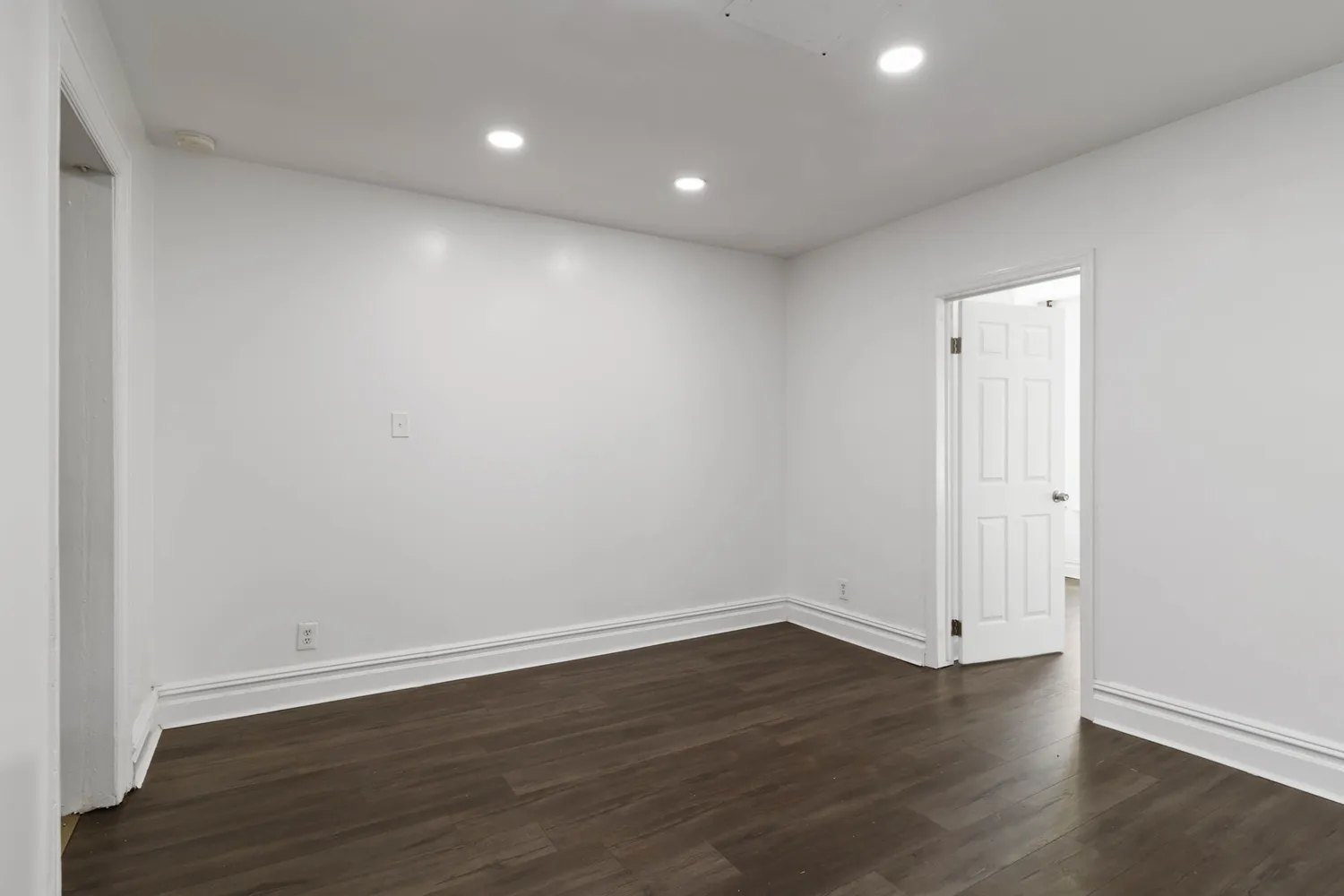 a view of a room with wooden floor