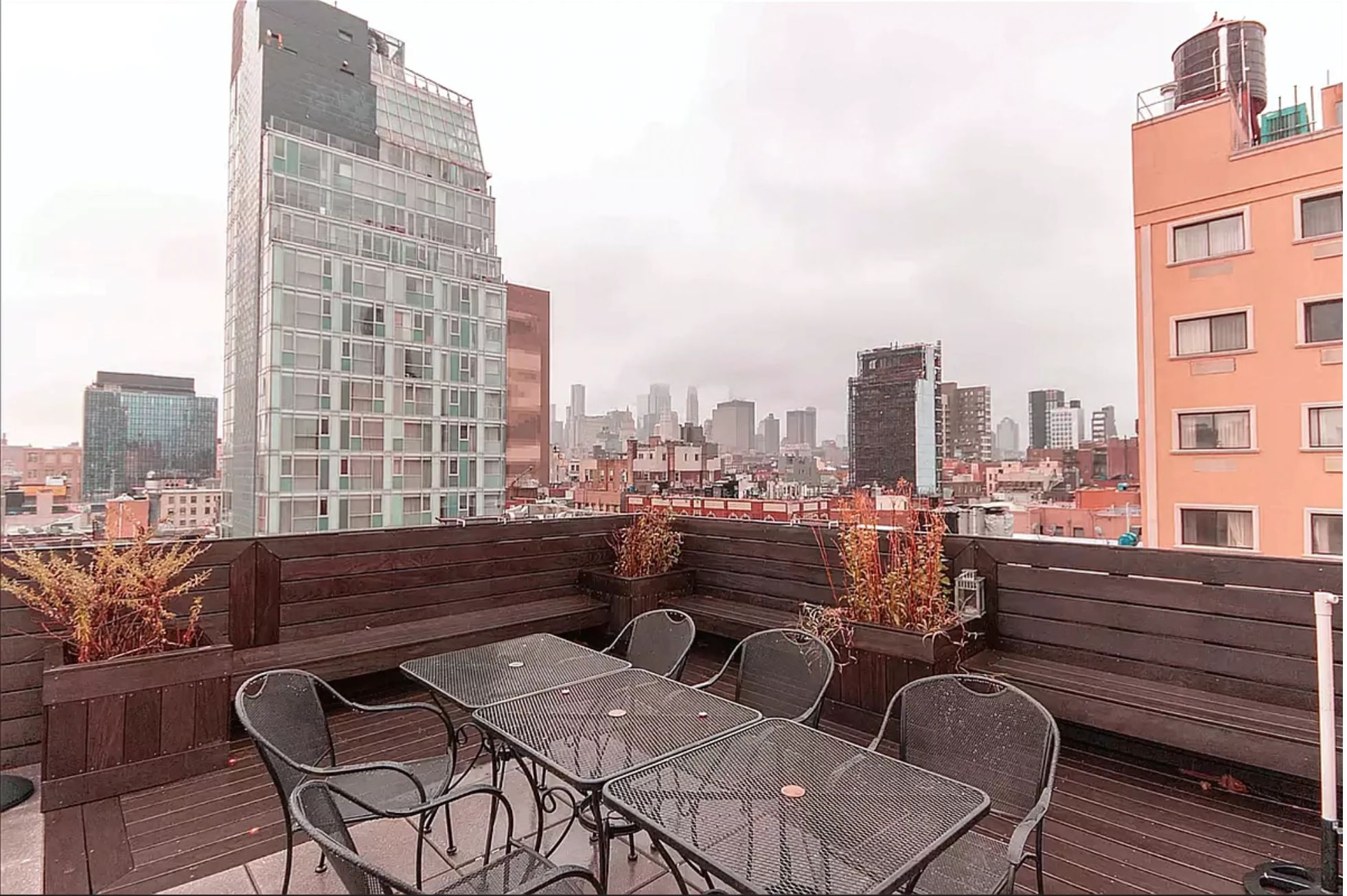 133 Essex Street, Unit 403 Manhattan, NY 10002 - Photo 7 of 7 a roof deck with couch and chairs
