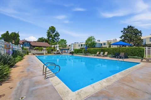 a view of swimming pool with outdoor seating and city view